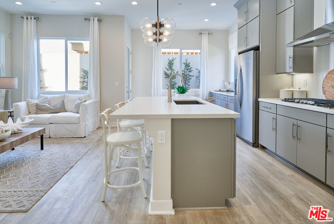 525 Daniel Freeman Circle Inglewood, CA 90301 - Photo 6 of 39 a kitchen with stainless steel appliances a table and chairs
