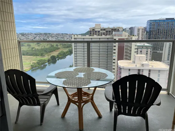 a view of balcony with table and chairs