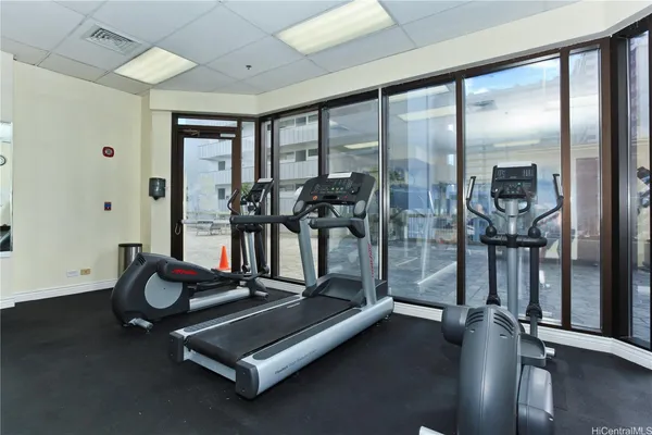 a room with gym equipment and a large window