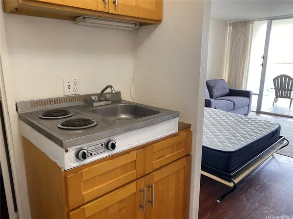 a stove top oven sitting inside of a kitchen