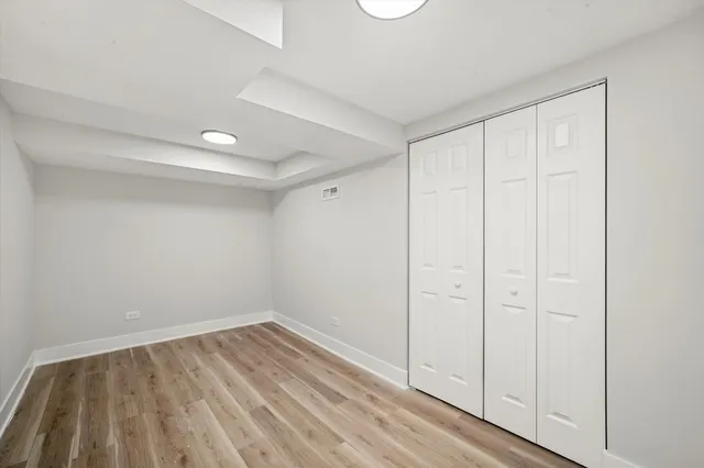 a view of a room with wooden floor