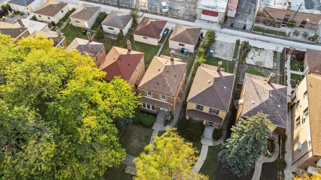 an aerial view of a house with a yard and garden