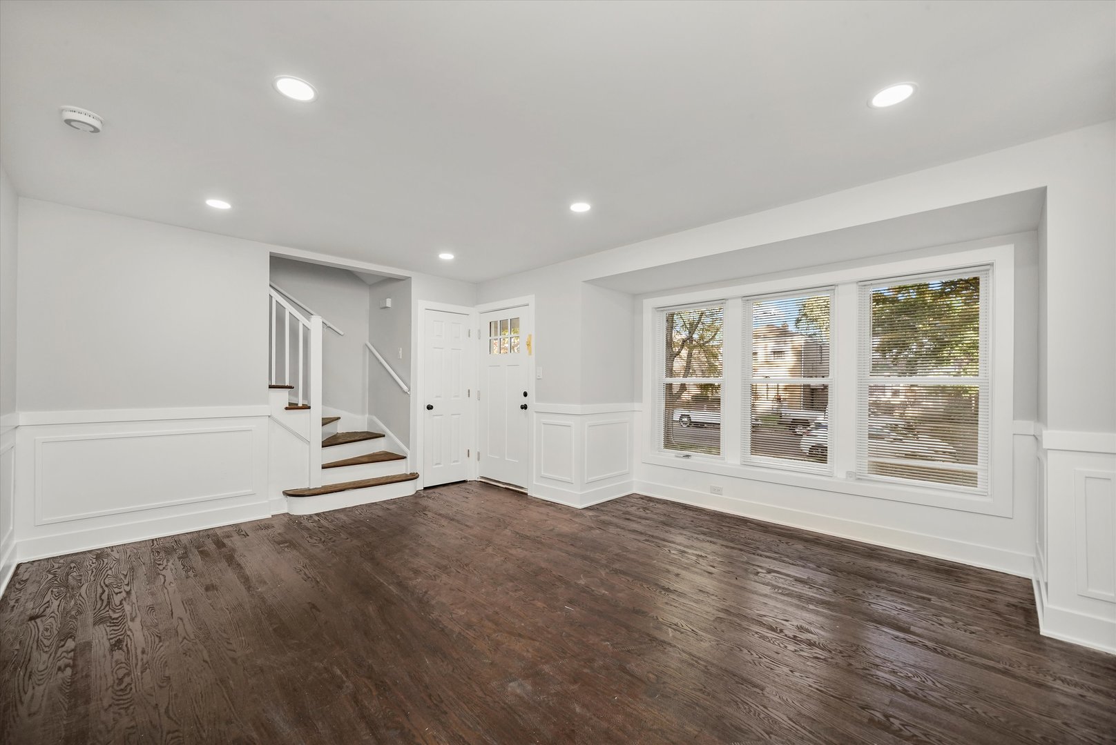 9322 South Justine Street Chicago, IL 60620 - Photo 3 of 27 an empty room with wooden floor and windows