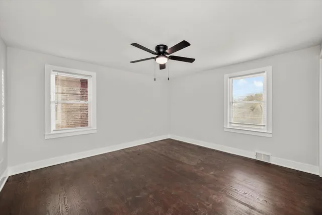 a view of a livingroom with a ceiling fan and window