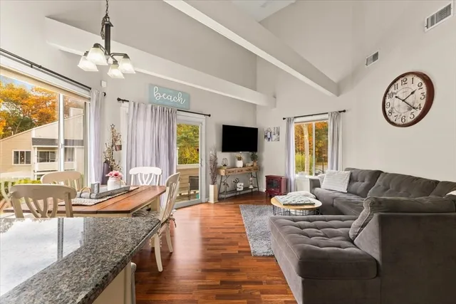 a living room with furniture a large window and a flat screen tv