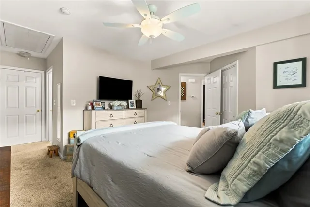 a bedroom with a bed tv and a window