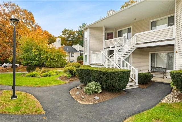 a front view of a house with a garden and patio