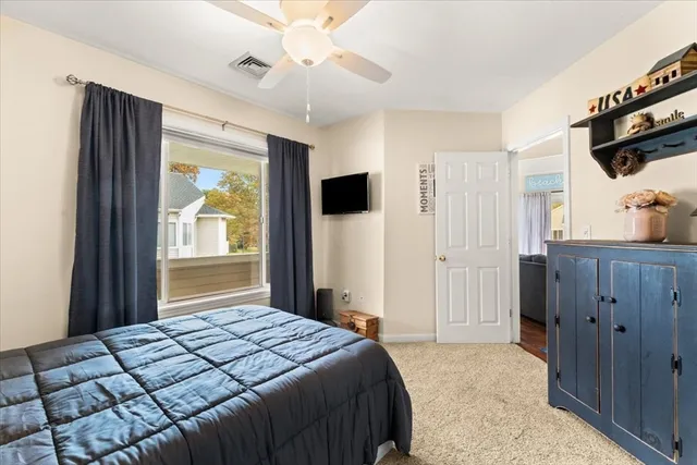 a bedroom with a bed and a flat tv screen