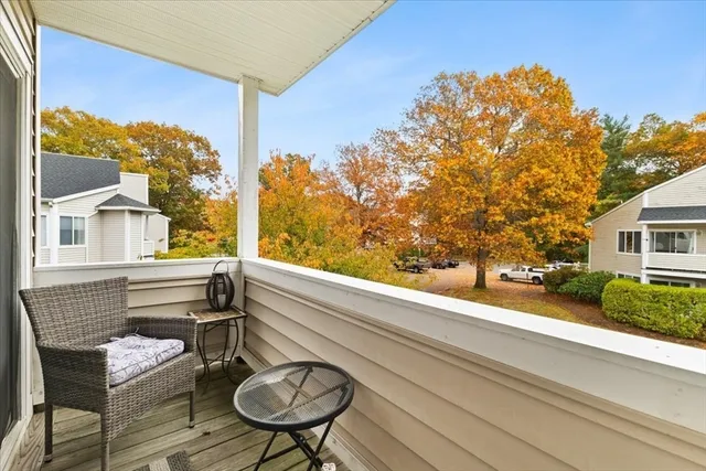 a view of a chair and tables in the balcony