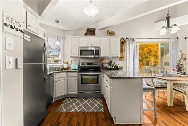 a kitchen with stainless steel appliances a stove a sink and a refrigerator