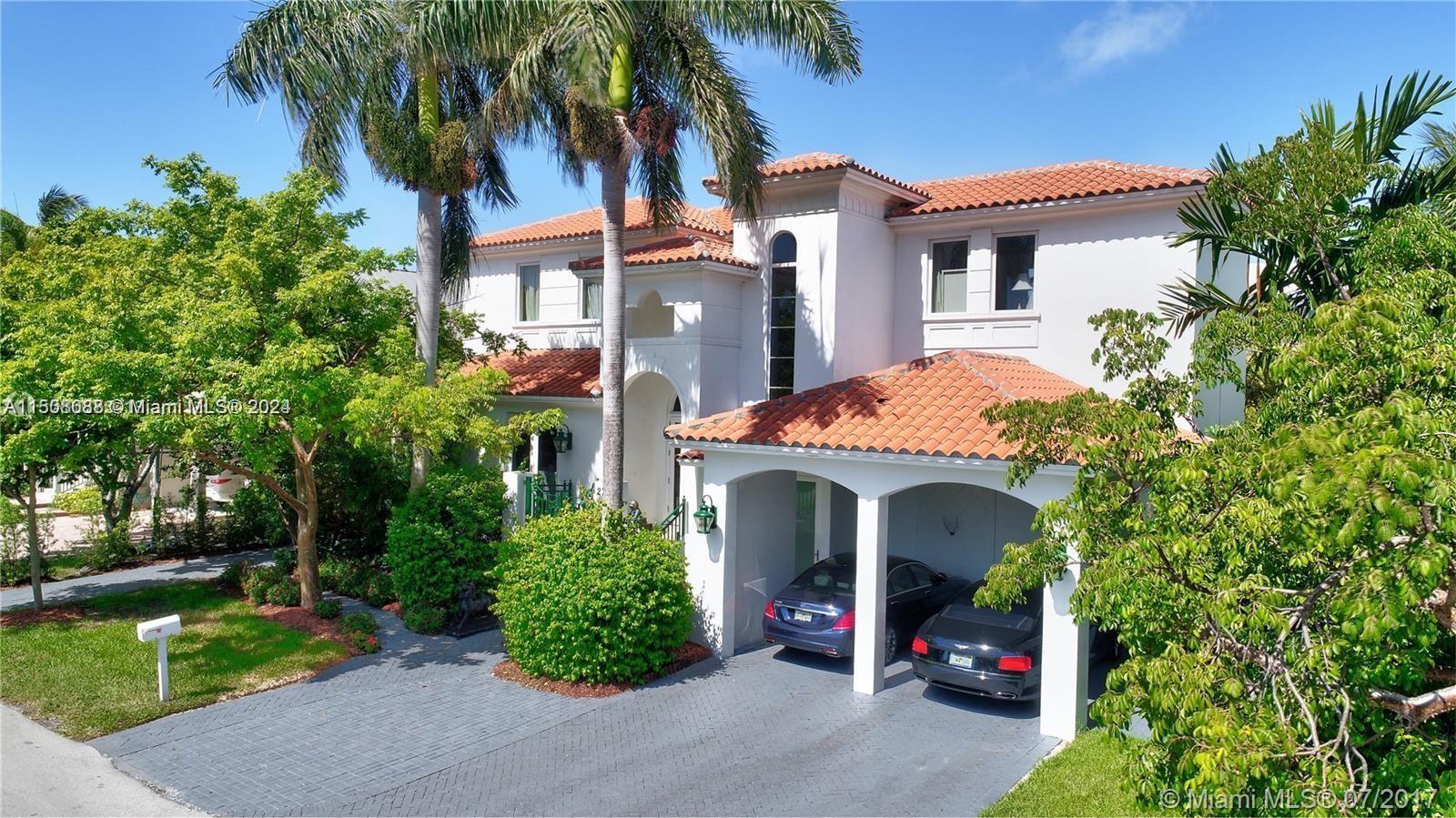 270 Ridgewood Road Key Biscayne, FL 33149 - Photo 1 of 15 a view of a house with a yard and potted plants