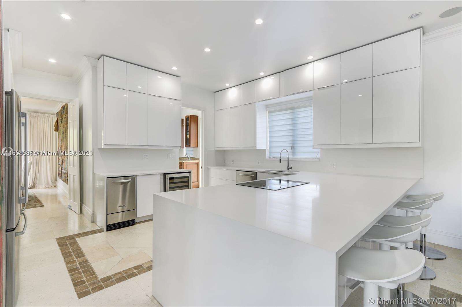 270 Ridgewood Road Key Biscayne, FL 33149 - Photo 11 of 15 a kitchen with refrigerator a stove and chairs