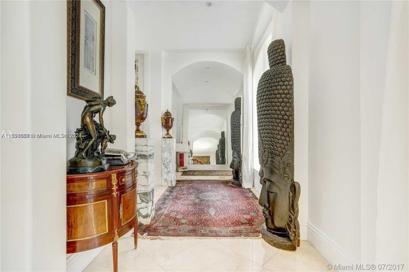 270 Ridgewood Road Key Biscayne, FL 33149 - Photo 5 of 15 a view of a hallway to a livingroom with wooden floor and furniture