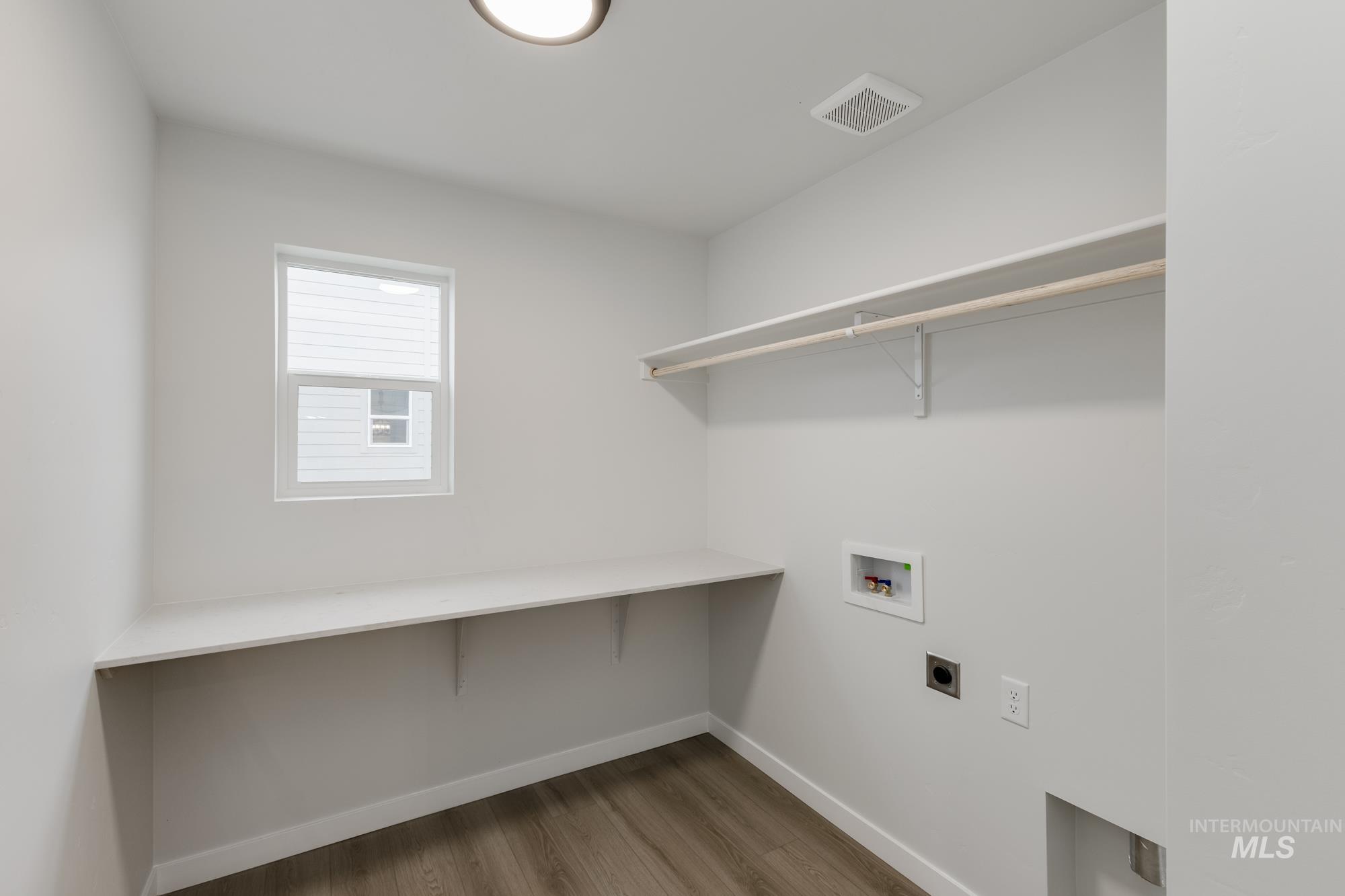 2086 South Border Way Meridian, ID 83642 - Photo 14 of 19 Laundry area featuring light wood-style flooring, electric dryer hookup, and washer hookup
