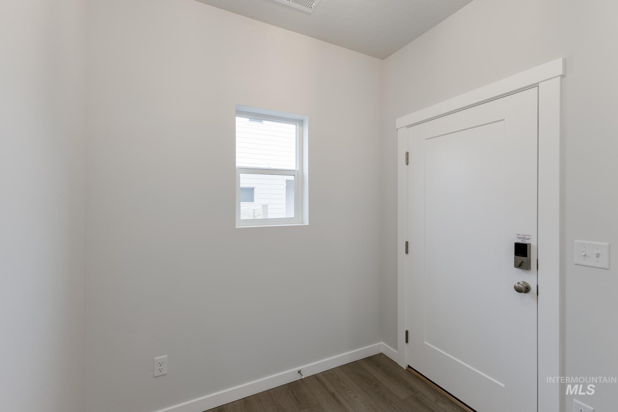 2086 South Border Way Meridian, ID 83642 - Photo 2 of 19 Doorway featuring baseboards and wood finished floors