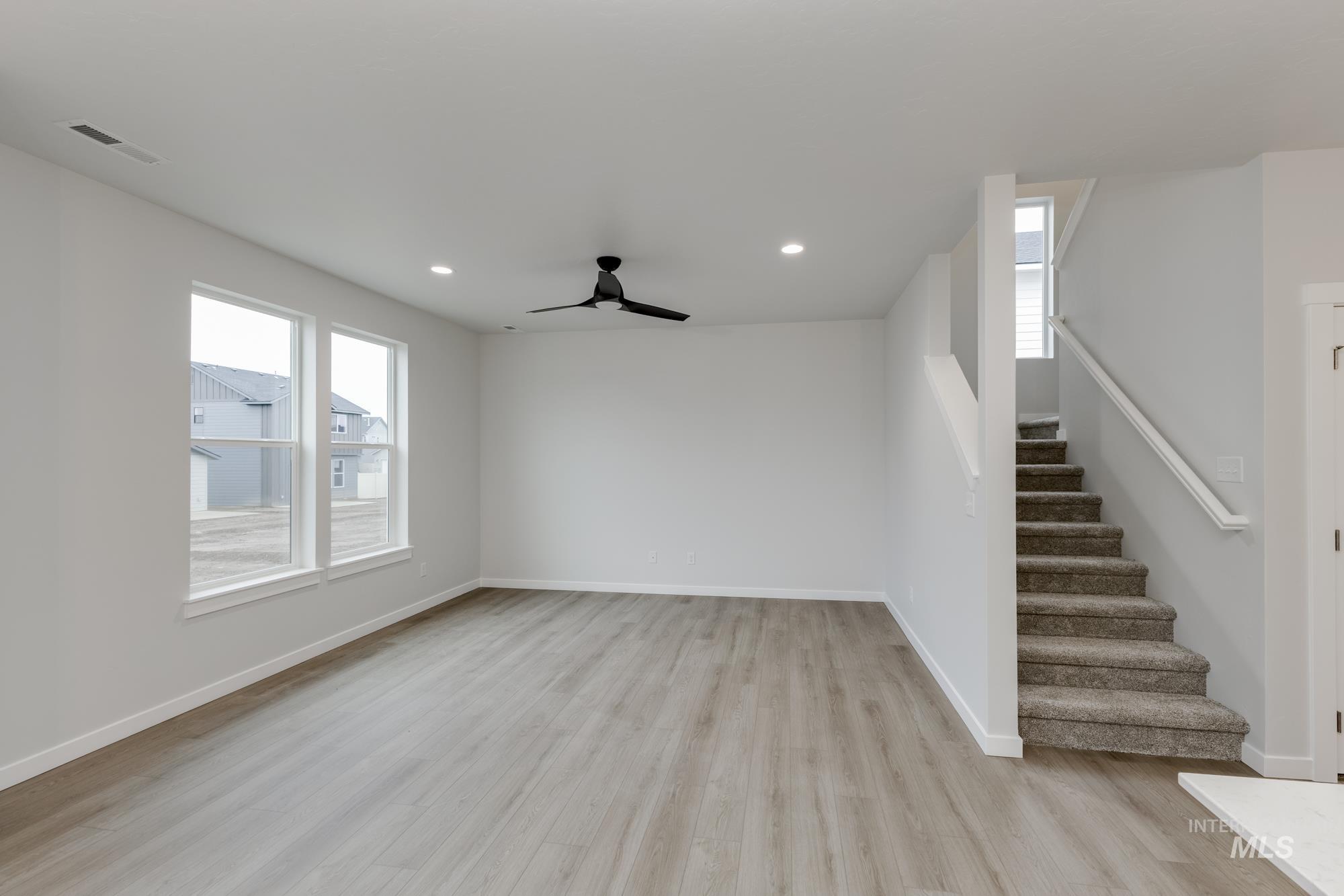 2086 South Border Way Meridian, ID 83642 - Photo 7 of 19 Unfurnished living room with light wood-style floors, ceiling fan, and recessed lighting