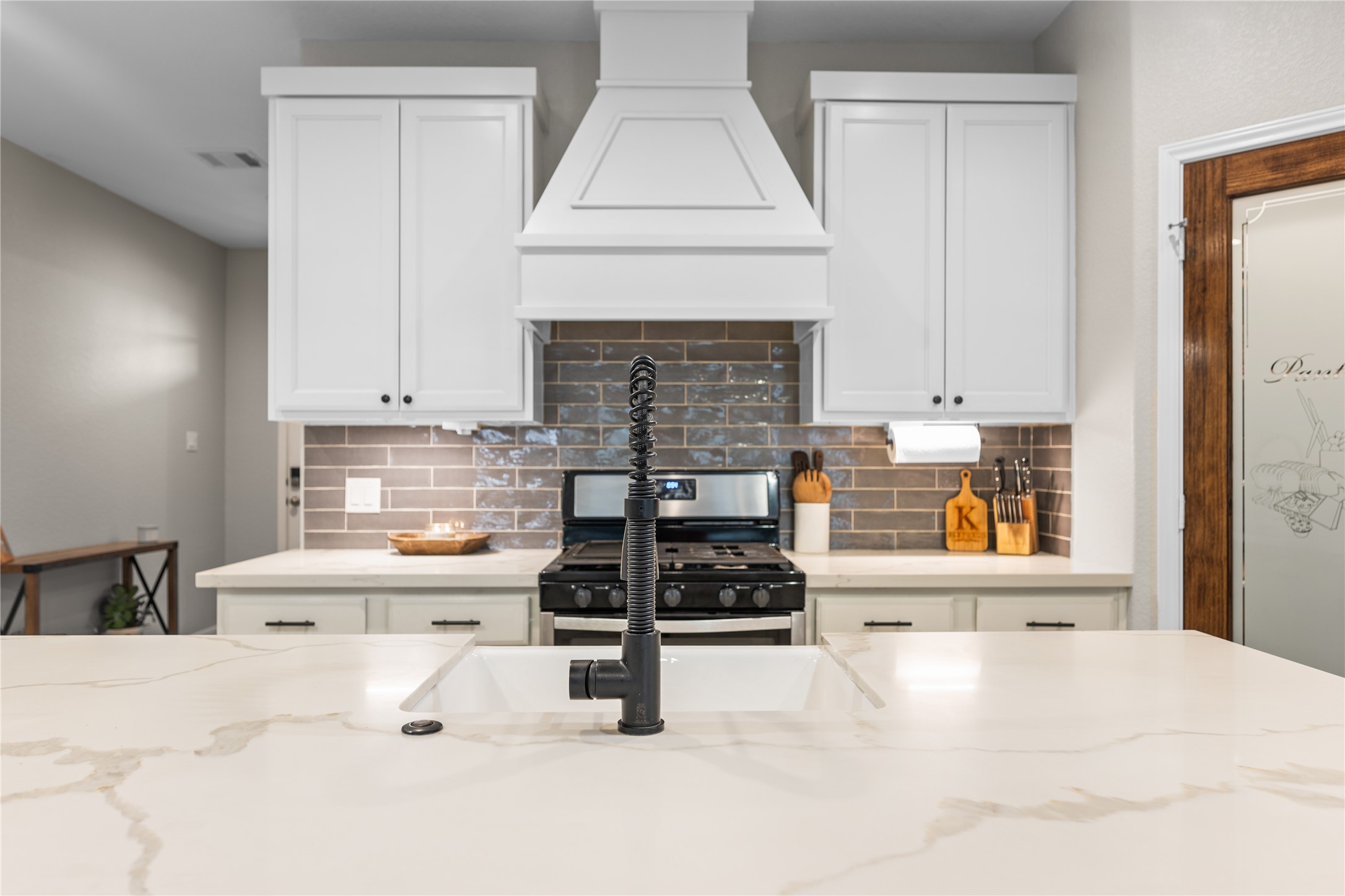 2504 Hagerman Road Conroe, TX 77384 - Photo 12 of 50 a kitchen with stainless steel appliances a stove a sink and a cabinets