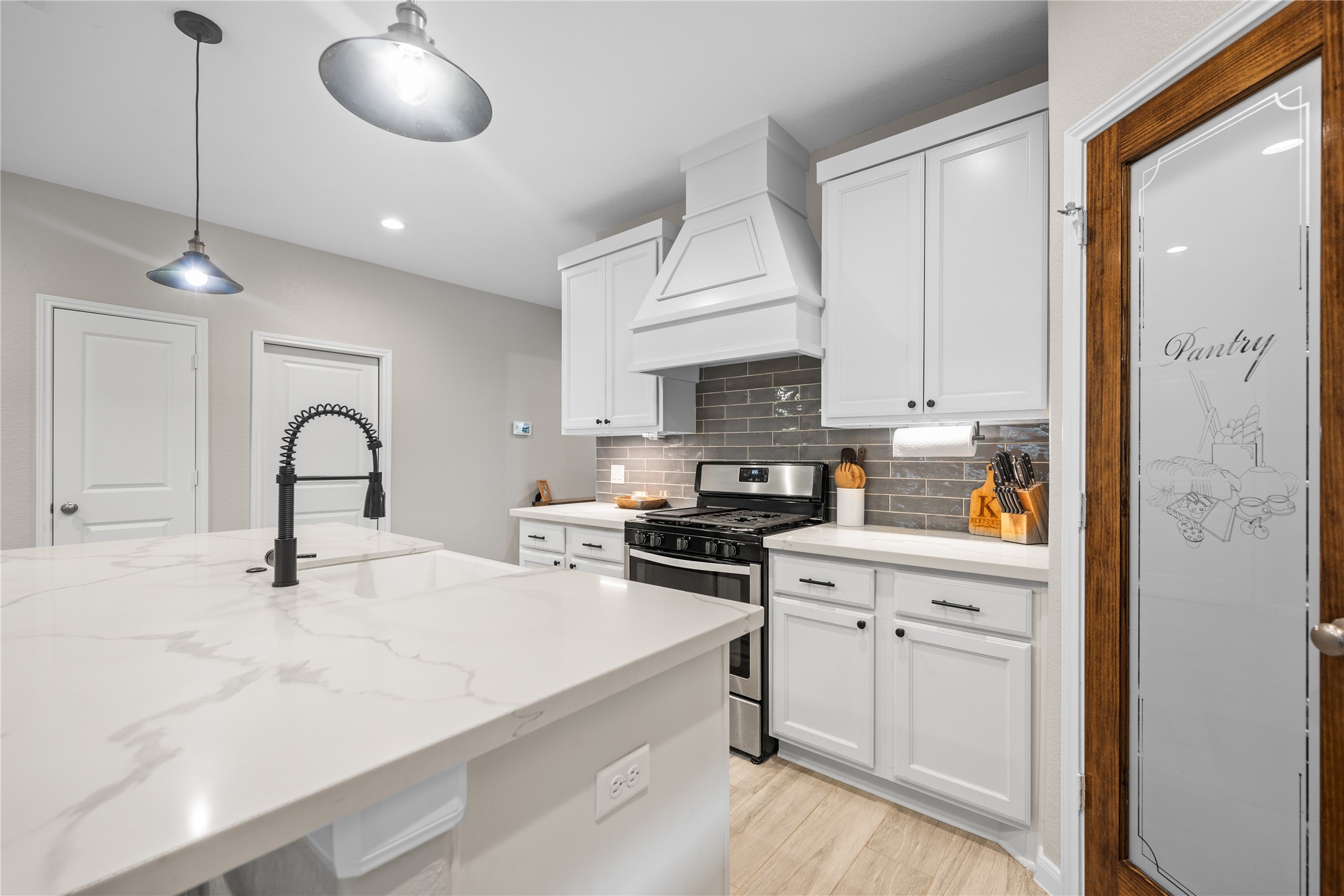 2504 Hagerman Road Conroe, TX 77384 - Photo 13 of 50 a kitchen with white cabinets and sink