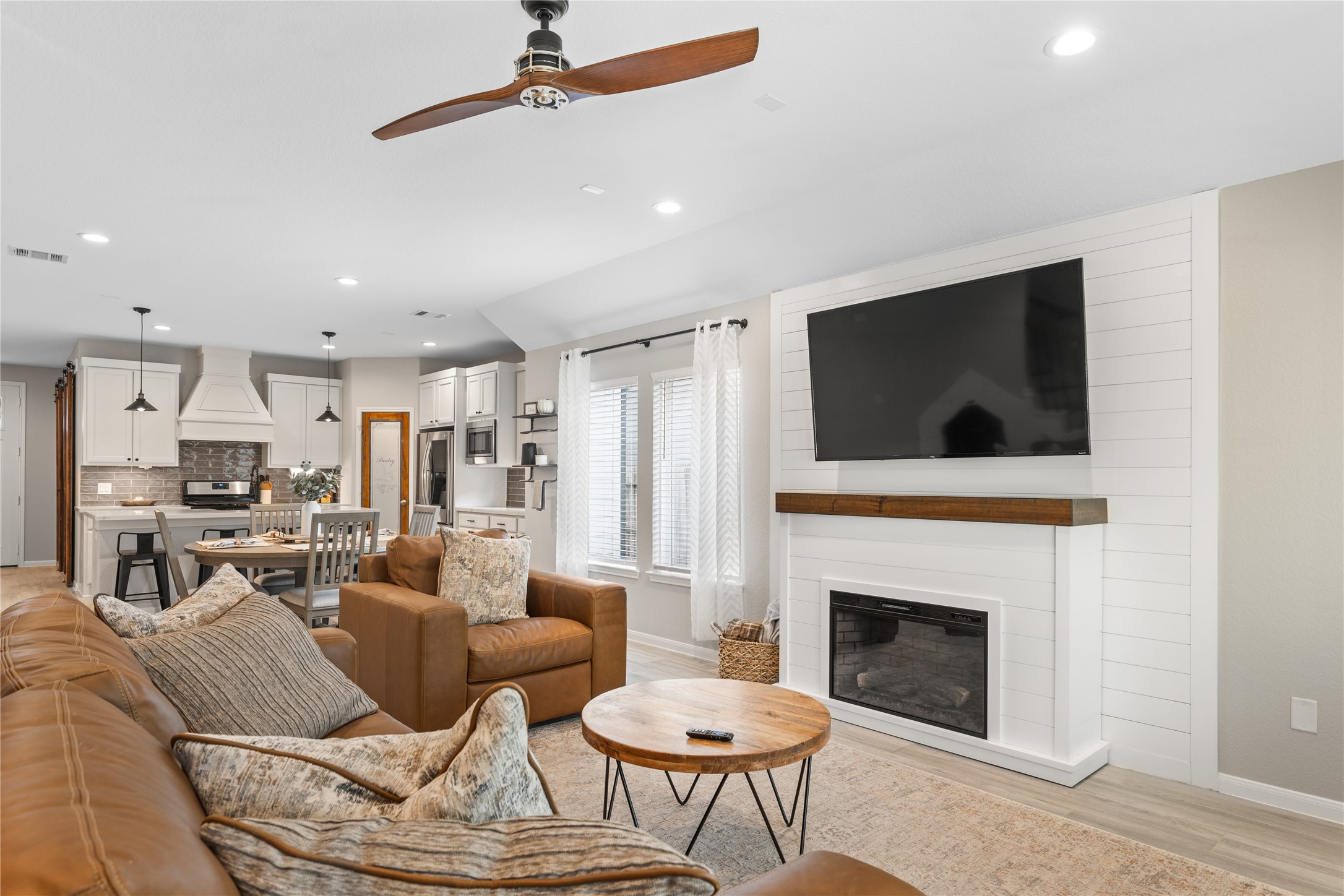 2504 Hagerman Road Conroe, TX 77384 - Photo 17 of 50 a living room with furniture a flat screen tv and a fireplace