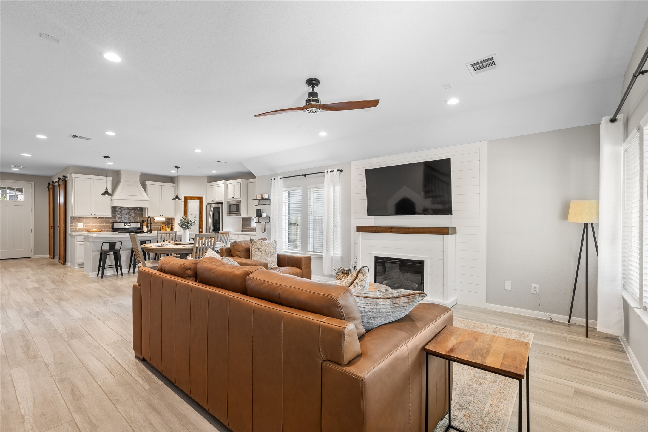 2504 Hagerman Road Conroe, TX 77384 - Photo 18 of 50 a living room with furniture a fireplace and a flat screen tv