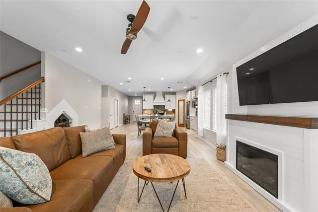 a living room with furniture a fireplace and a flat screen tv