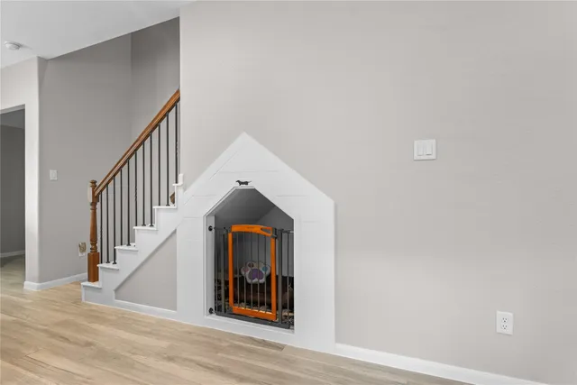 a view of entryway and hall with wooden floor