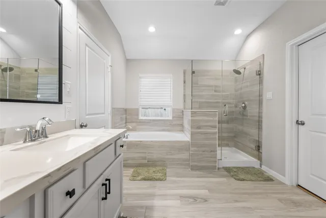 a bathroom with double vanity and a shower