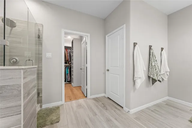 a view of a bathroom with wooden floor and a bathroom