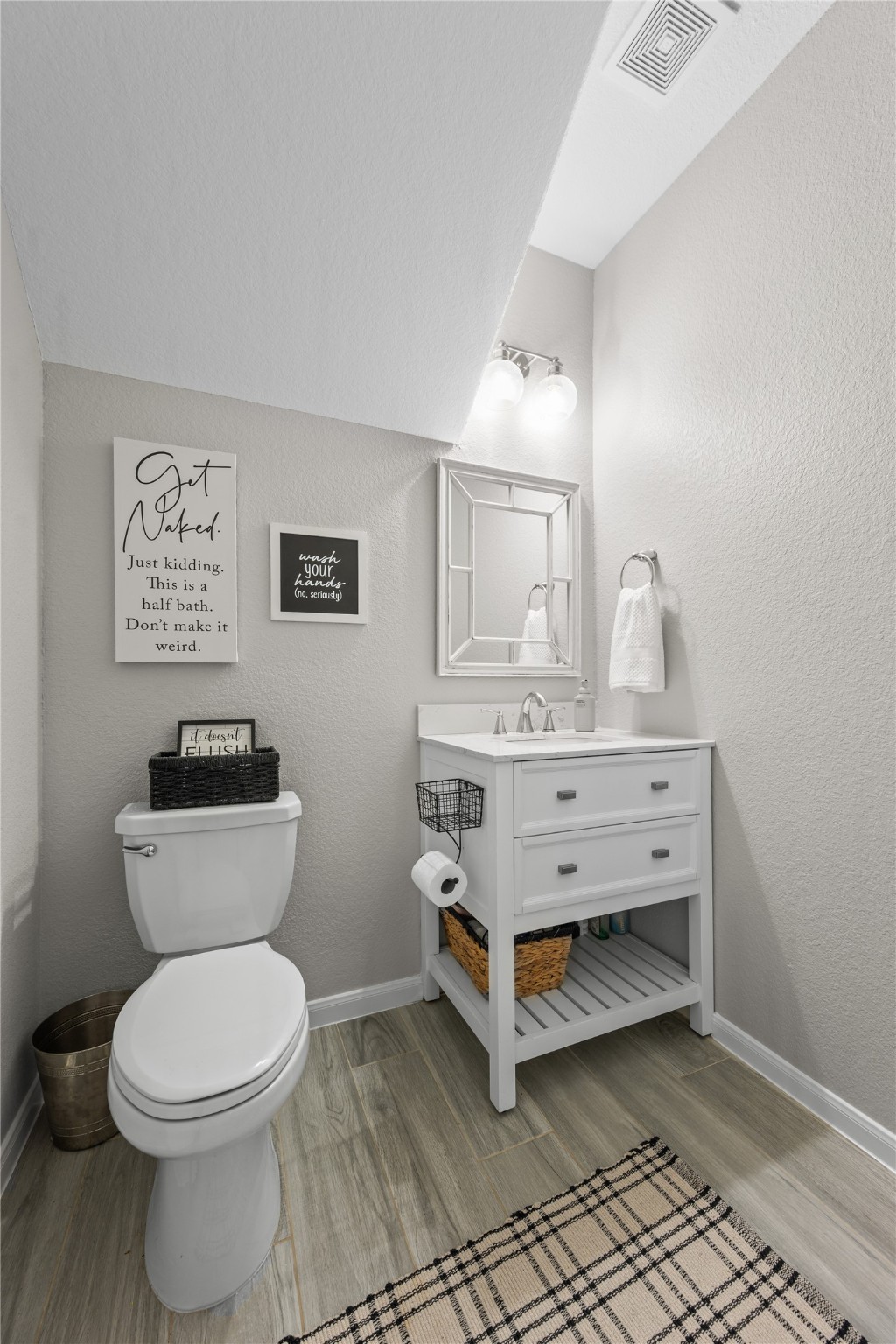 2504 Hagerman Road Conroe, TX 77384 - Photo 31 of 50 a bathroom with a sink mirror vanity and toilet