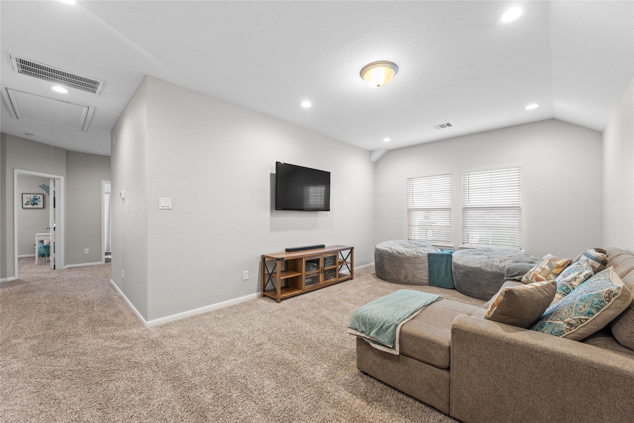 2504 Hagerman Road Conroe, TX 77384 - Photo 34 of 50 a living room with furniture and a flat screen tv