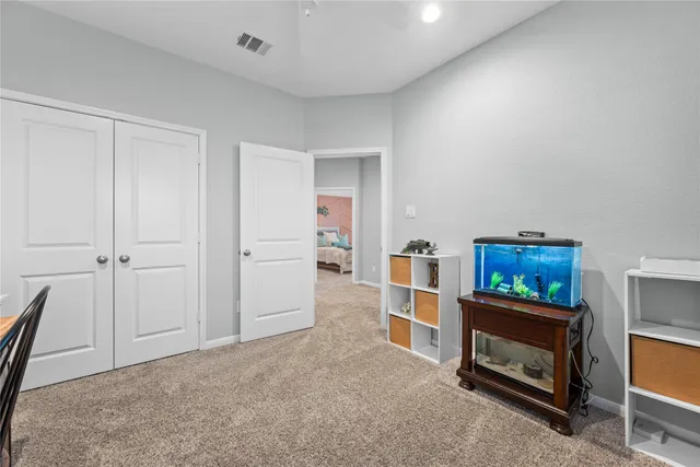 a bathroom with a granite countertop sink a toilet and a mirror