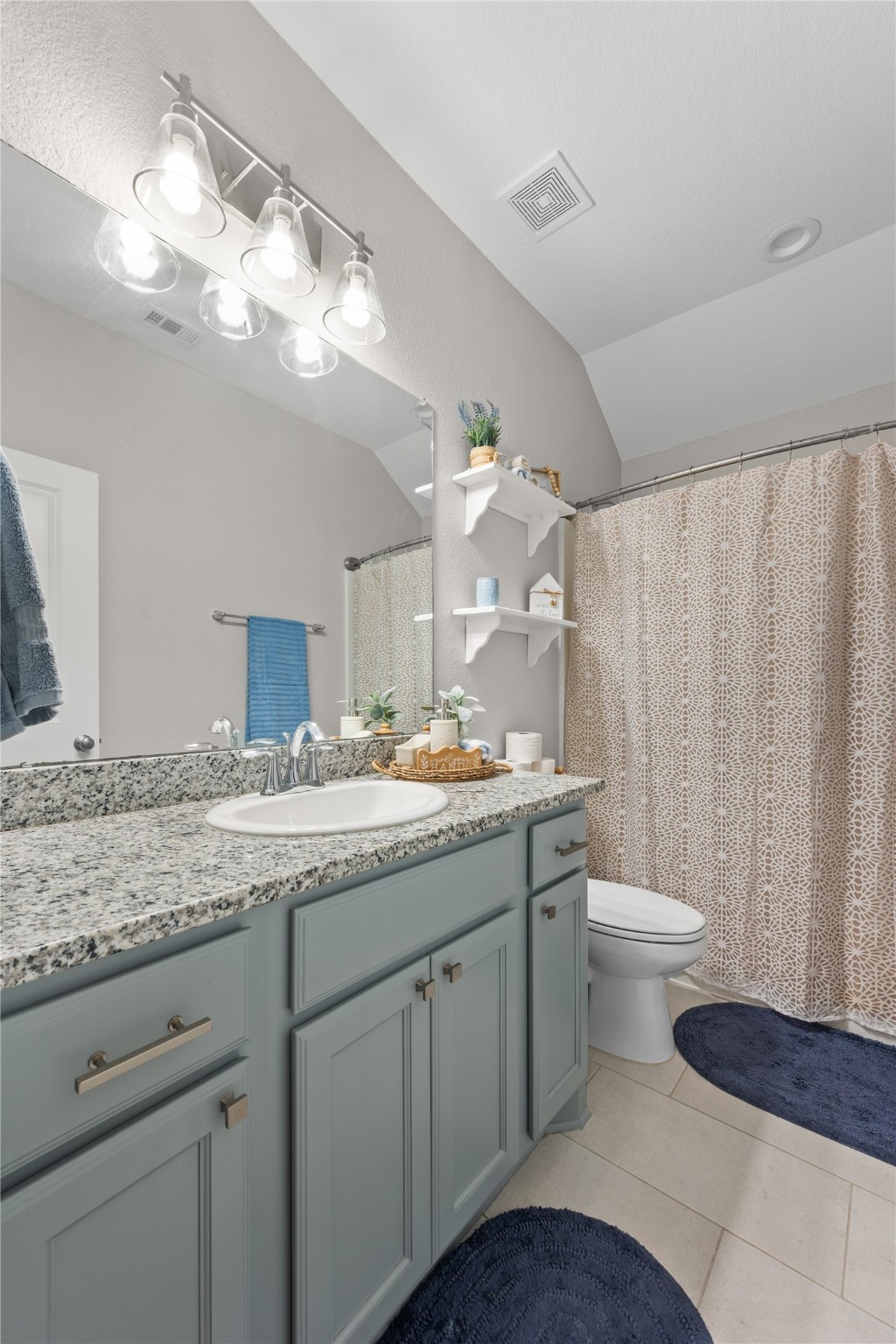 2504 Hagerman Road Conroe, TX 77384 - Photo 41 of 50 a bathroom with a granite countertop sink a toilet and a mirror
