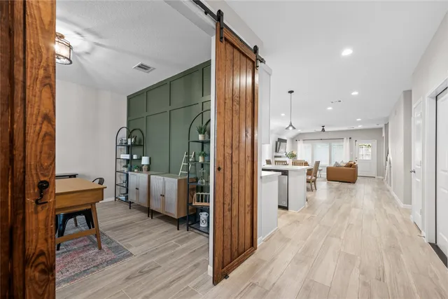 a view of a living room kitchen and a wooden floor