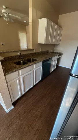 a view of a kitchen counter space and wooden floor