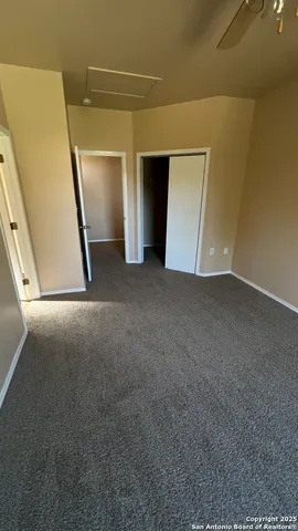 a view of a swimming pool with a fountain and large trees
