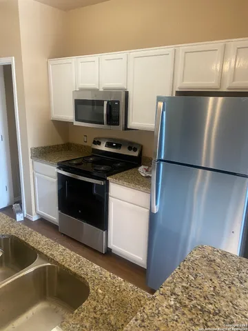 a kitchen with a stove and a microwave