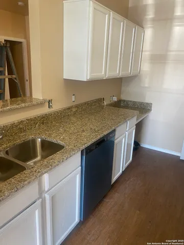 a kitchen with stainless steel appliances granite countertop a sink and a granite counter tops