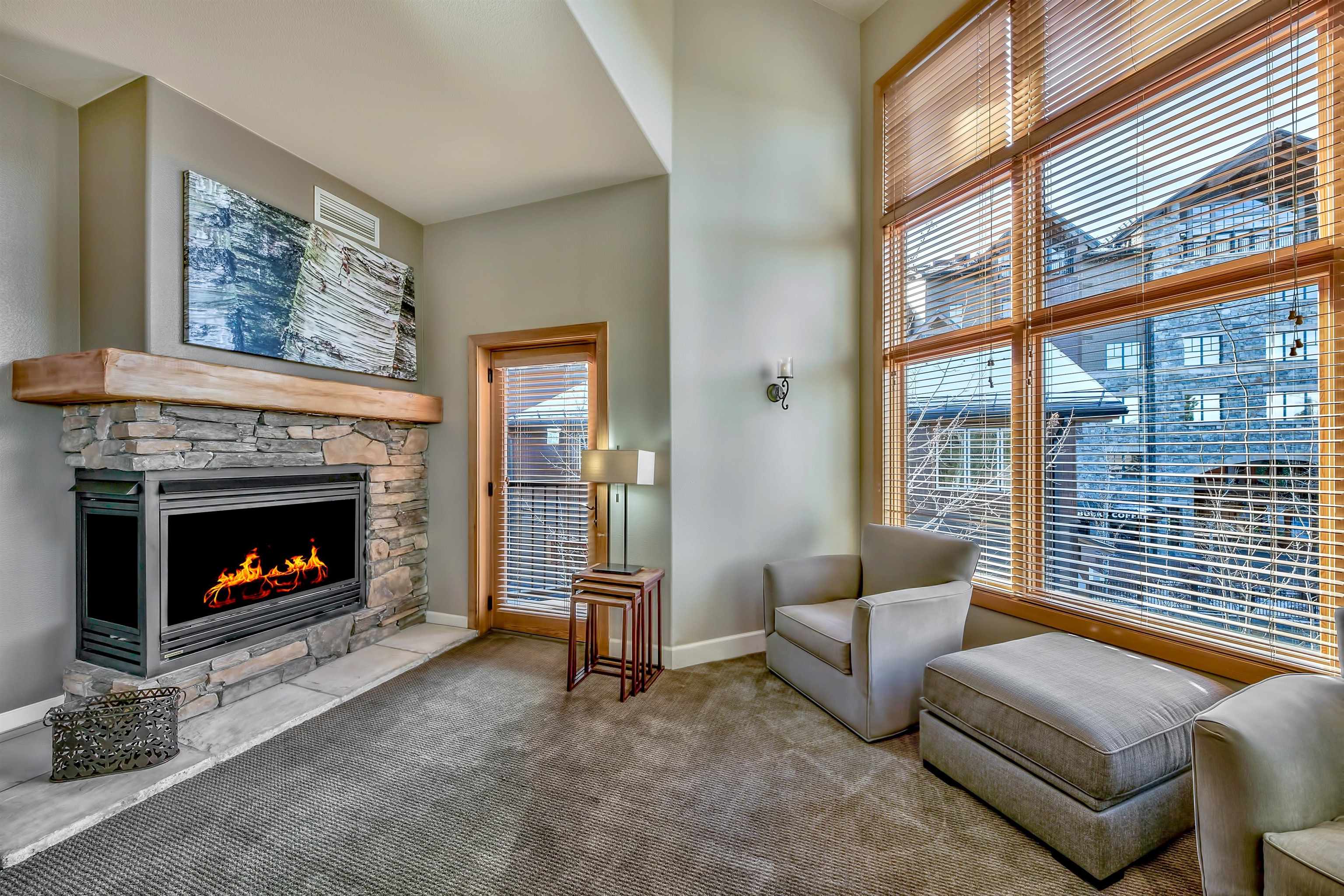 2100 North Village Drive, Unit 202/2 Truckee, CA 96161 - Photo 4 of 20 a living room with furniture a floor to ceiling window and a fireplace