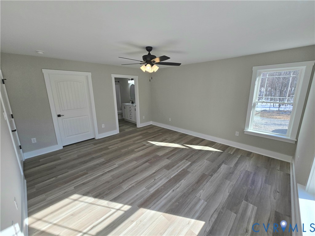 1781 Bumpass Road Bumpass, VA 23024 - Photo 18 of 26 a view of empty room with wooden floor and fan