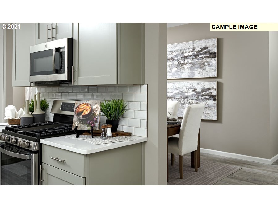 3002 North Mccanta Way Ridgefield, WA 98642 - Photo 5 of 10 a kitchen with a stove a sink and a microwave