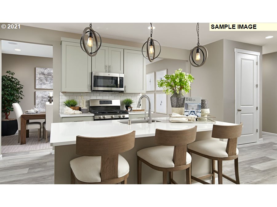 3002 North Mccanta Way Ridgefield, WA 98642 - Photo 6 of 10 a kitchen with a table chairs and a stove