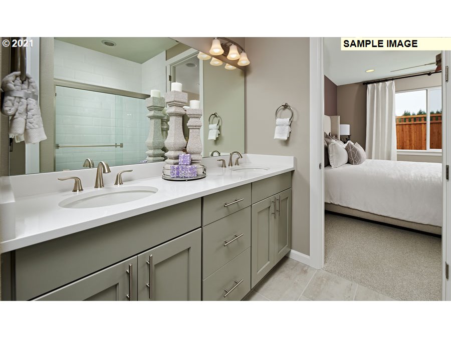 3002 North Mccanta Way Ridgefield, WA 98642 - Photo 7 of 10 a en suite bathroom with a double vanity sink and a mirror