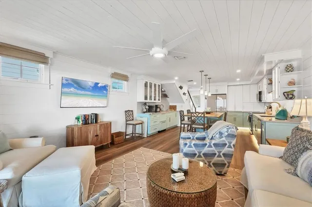 a living room with furniture and kitchen view