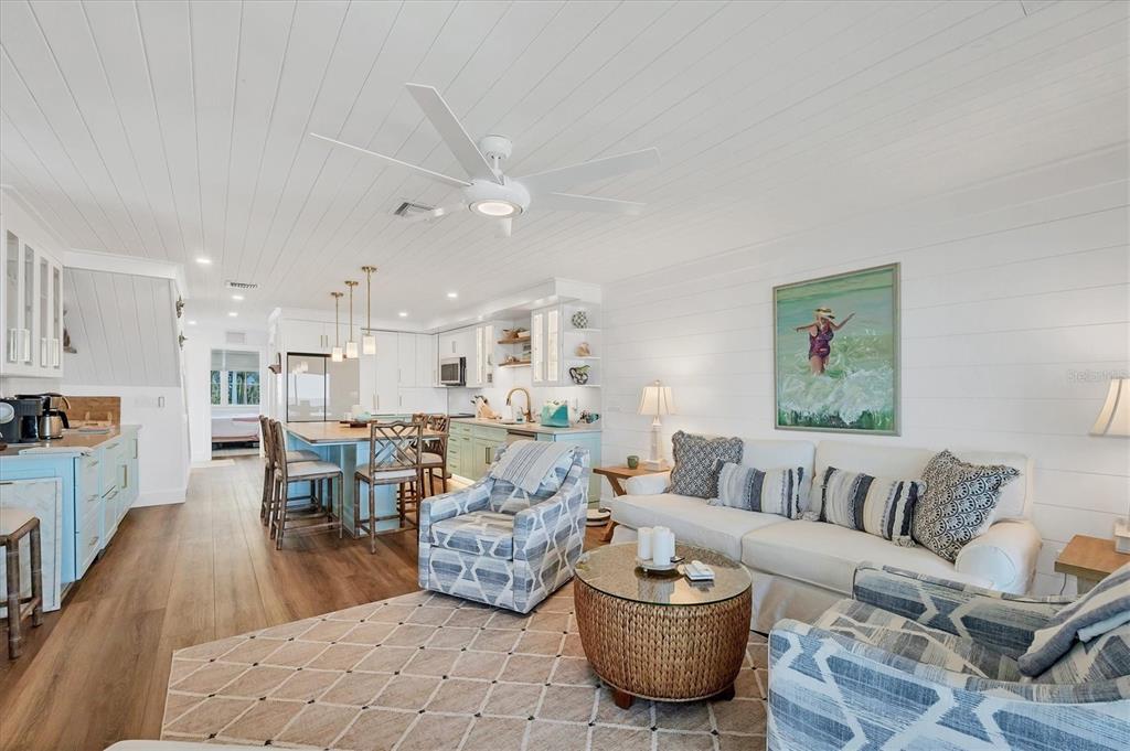290 Gulf Boulevard, Unit 17 Boca Grande, FL 33921 - Photo 12 of 39 a living room with furniture and a dining table with kitchen view