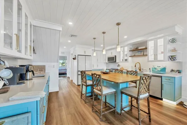 a large kitchen with a table and chairs in it