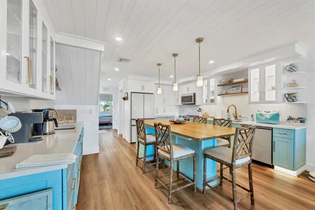 a large kitchen with a table and chairs in it