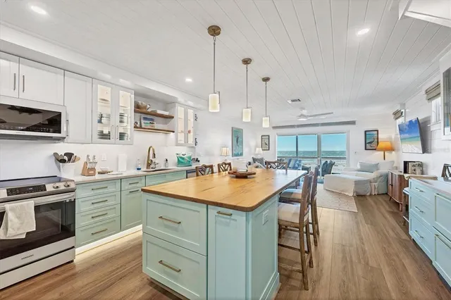 a kitchen with a sink stove and wooden cabinets
