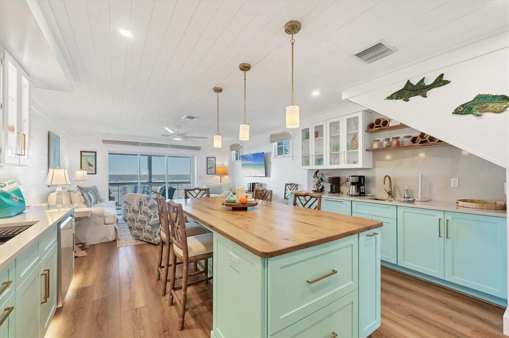 290 Gulf Boulevard, Unit 17 Boca Grande, FL 33921 - Photo 16 of 39 a kitchen with a table chairs stove and wooden floor