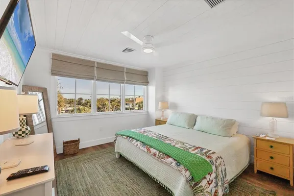 a bedroom with a bed and a mirror