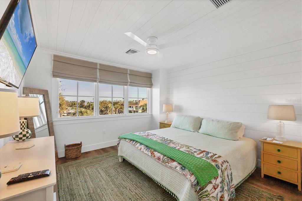 290 Gulf Boulevard, Unit 17 Boca Grande, FL 33921 - Photo 24 of 39 a bedroom with a bed and a mirror